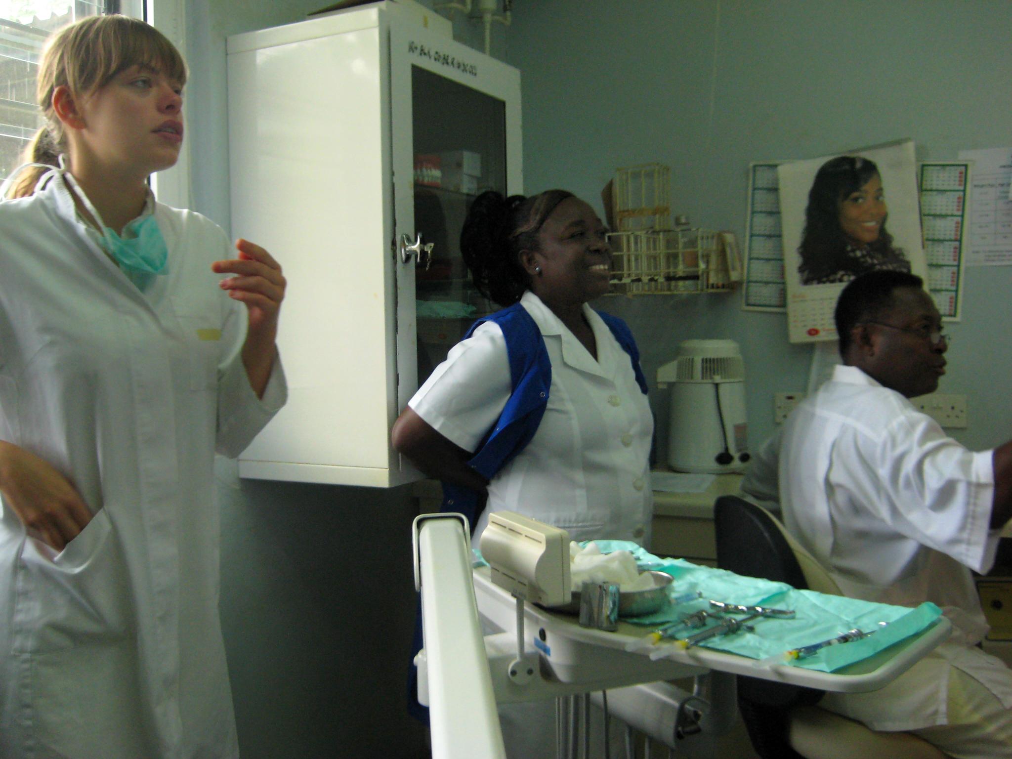 A Dentistry intern in Ghana takes part in a meeting with local medical staff at a hospital Two local dentists involve a Projects Abroad dental intern in one of their meetings at a hospital in Ghana.